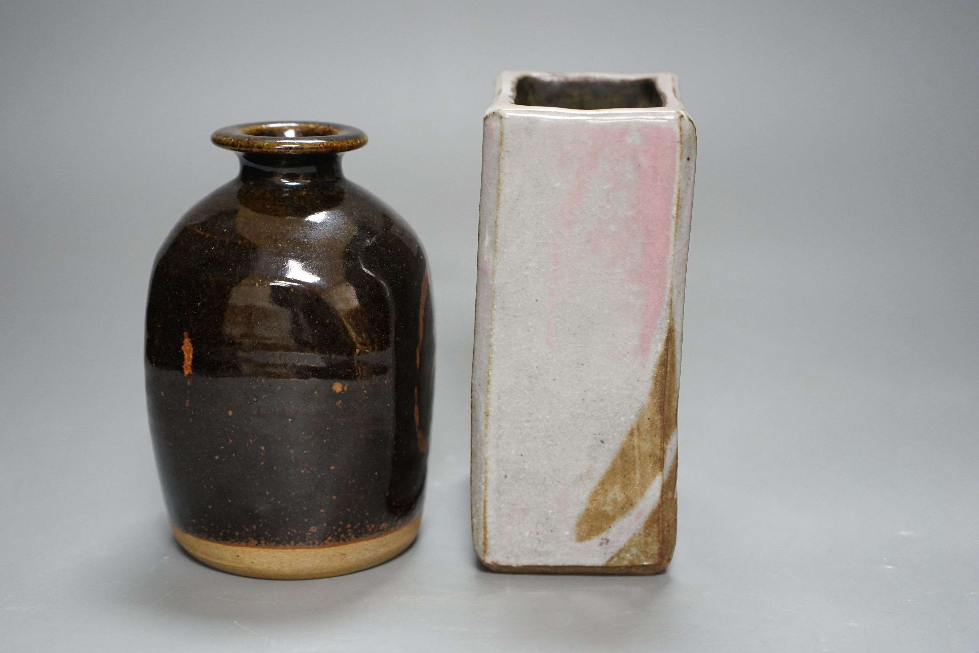 British Studio Pottery; a tenmoku glazed bottle vase, with impressed mark, together with an abstract rectangular blue glaze vase with brown and pink undertones, unmarked, 15cm tall, (2)